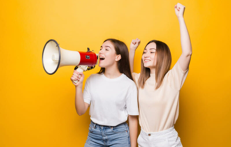 dos-amigas-mujeres-jovenes-gritan-megafono-ofertas